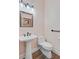 Small powder room featuring a pedestal sink, modern faucet and white toilet at 225 Ridge Rd, Ridgeville, SC 29472