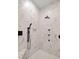 Modern shower featuring a marble tile surround, rainfall shower head, and separate handheld sprayer at 225 Ridge Rd, Ridgeville, SC 29472