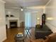 Spacious living room with a fireplace, ceiling fan, and sliding glass doors at 2314 Treescape Dr # 2406, Charleston, SC 29414
