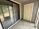 A view of the screened in porch with tiled floors and door to yard at 2314 Treescape Dr # 2406, Charleston, SC 29414
