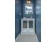 Stylish blue half-bathroom featuring a modern white vanity with glass-door storage and a sleek mirror at 247 Darcy Ave, Goose Creek, SC 29445