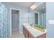 Bathroom features a long vanity, an undermounted sink and a light blue shower curtain in the corner at 247 Darcy Ave, Goose Creek, SC 29445