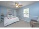 Comfortable bedroom with a queen bed, soft carpet, and a large window for natural light at 247 Darcy Ave, Goose Creek, SC 29445