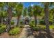 Community pool house entrance, framed by mature palm trees, inviting residents to enjoy a refreshing swim at 247 Darcy Ave, Goose Creek, SC 29445