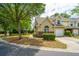 Charming tan townhouse with brick accents, manicured landscaping, and an attached single-car garage at 247 Darcy Ave, Goose Creek, SC 29445