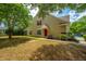 Charming tan home with a red front door, green grass, and mature trees at 247 Darcy Ave, Goose Creek, SC 29445