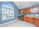 Bright kitchen with a large window, wooden cabinets, and modern appliances at 247 Darcy Ave, Goose Creek, SC 29445