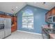 Bright kitchen with stainless steel appliances, cherry cabinets and a large arched window at 247 Darcy Ave, Goose Creek, SC 29445