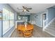 Open-concept living room with wood floors, fireplace, and adjacent dining area with a round wooden table at 247 Darcy Ave, Goose Creek, SC 29445