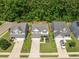 An aerial view showing homes with well-manicured lawns and a lush green backdrop at 259 Weeping Cypress Dr, Moncks Corner, SC 29461
