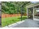 Well-manicured backyard with a pergola, privacy fence, screened-in porch, and a lush lawn at 259 Weeping Cypress Dr, Moncks Corner, SC 29461