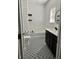 Chic bathroom featuring a tub, a designer vanity, and decorative patterned tile flooring at 259 Weeping Cypress Dr, Moncks Corner, SC 29461