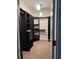 Spacious walk-in closet with custom shelving and dark wood accents at 259 Weeping Cypress Dr, Moncks Corner, SC 29461