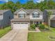 Charming two-story home with a two-car garage, manicured lawn, and delightful landscaping at 259 Weeping Cypress Dr, Moncks Corner, SC 29461
