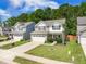 Charming two-story home with a two-car garage, well-maintained lawn, and lush landscaping at 259 Weeping Cypress Dr, Moncks Corner, SC 29461