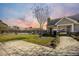 Community clubhouse with a swimming pool and a manicured lawn against a vibrant sunset sky at 259 Weeping Cypress Dr, Moncks Corner, SC 29461