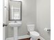Simple and modern half-bathroom featuring a pedestal sink and toilet at 2909 Swamp Sparrow Cir, Johns Island, SC 29455