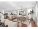 Open-concept dining room and kitchen featuring sleek, white cabinetry and stainless steel appliances at 2909 Swamp Sparrow Cir, Johns Island, SC 29455