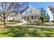 Charming gray two-story home with a inviting front porch and well-maintained lawn on a bright day at 2909 Swamp Sparrow Cir, Johns Island, SC 29455