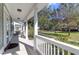 Inviting front porch featuring white columns and railing, offering a pleasant outdoor space overlooking the lawn at 2909 Swamp Sparrow Cir, Johns Island, SC 29455