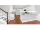 Modern kitchen featuring white cabinets, granite countertops, stainless steel appliances, and hardwood floors at 2909 Swamp Sparrow Cir, Johns Island, SC 29455