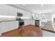 Spacious white kitchen with stainless steel appliances, granite countertops, hardwood floors and ample cabinet space at 2909 Swamp Sparrow Cir, Johns Island, SC 29455
