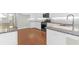 Bright kitchen featuring white cabinets, granite countertops, stainless steel appliances, and hardwood floors at 2909 Swamp Sparrow Cir, Johns Island, SC 29455