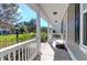 Inviting front porch with white railing, offering a relaxing outdoor space with views of a manicured lawn at 2909 Swamp Sparrow Cir, Johns Island, SC 29455