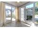 Bright sunroom features walls of windows with light curtains and durable flooring at 2909 Swamp Sparrow Cir, Johns Island, SC 29455