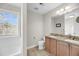 Bathroom featuring a granite countertop on a double sink vanity, with tile floors and natural light at 2919 Zachary George Ln, Johns Island, SC 29455
