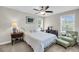 Bedroom with a white comforter, chair, and footstool alongside a side table and bureau at 2919 Zachary George Ln, Johns Island, SC 29455
