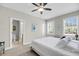 Bedroom with natural light from two windows, a ceiling fan, carpet, and a glimpse into the bathroom at 2919 Zachary George Ln, Johns Island, SC 29455
