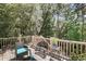 Beautiful deck area featuring stylish outdoor furniture and serene views of the surrounding trees at 2919 Zachary George Ln, Johns Island, SC 29455