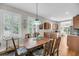Charming dining room featuring hardwood floors, natural light, and adjacent kitchen views at 2919 Zachary George Ln, Johns Island, SC 29455