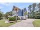 Two-story blue home with a spacious paved driveway and mature palm trees at 2919 Zachary George Ln, Johns Island, SC 29455