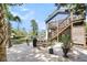View of the home's exterior with stairs, a grill, a lush yard, and a glimpse of the neighbor's house at 2919 Zachary George Ln, Johns Island, SC 29455