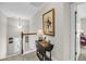 Upstairs landing with a drop-leaf table, paintings, and stairs leading to another level at 2919 Zachary George Ln, Johns Island, SC 29455