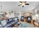 Inviting living room featuring hardwood floors, ceiling fan, blue accents, and comfortable leather seating at 2919 Zachary George Ln, Johns Island, SC 29455