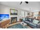 Comfortable living room with a fireplace, ceiling fan, hardwood floors, and adjacent kitchen at 2919 Zachary George Ln, Johns Island, SC 29455