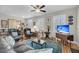 Bright living room showcasing hardwood floors, plantation shutters, a ceiling fan, and comfortable seating at 2919 Zachary George Ln, Johns Island, SC 29455