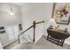 Carpeted staircase with pictures on the wall, a side table, and a vase with flowers at 2919 Zachary George Ln, Johns Island, SC 29455