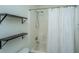 Bright bathroom features a shower/tub combo, shelving and a patterned shower curtain at 2954 Woodland Park Dr, Mount Pleasant, SC 29466