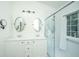 Elegant bathroom featuring double vanity sinks, modern lighting, and a separate shower with glass doors at 2954 Woodland Park Dr, Mount Pleasant, SC 29466