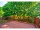 Spacious wooden deck with railing, perfect for outdoor relaxation and enjoying the surrounding trees and sunlight at 2954 Woodland Park Dr, Mount Pleasant, SC 29466
