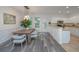 Charming dining area open to kitchen, featuring stylish chairs, wood table, and modern lighting at 2954 Woodland Park Dr, Mount Pleasant, SC 29466