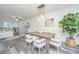 Open-concept dining area with modern lighting fixture, stylish chairs, and views into the living room at 2954 Woodland Park Dr, Mount Pleasant, SC 29466