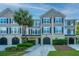 Charming townhome exterior with grey siding, black shutters, well-manicured landscaping, and private garages at 2954 Woodland Park Dr, Mount Pleasant, SC 29466
