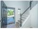 Bright foyer with staircase, light grey steps, white railings, and a glimpse of the outdoors at 2954 Woodland Park Dr, Mount Pleasant, SC 29466