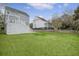 Spacious backyard featuring lush green grass, mature trees, and a beautiful deck area for outdoor entertaining at 303 S Ladd Ct, Charleston, SC 29492