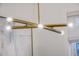 Modern chandelier with metal arms and exposed light bulbs, complemented by an abstract painting on the wall at 303 S Ladd Ct, Charleston, SC 29492